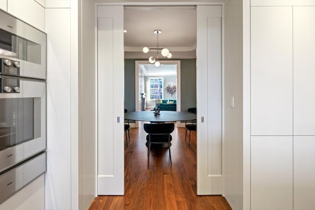 hallway featuring crown molding and wood finished floors