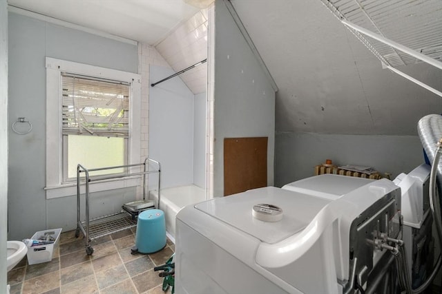 laundry area with stone finish floor, laundry area, and washer and clothes dryer