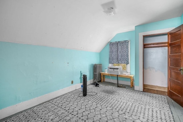additional living space featuring baseboards, lofted ceiling, and radiator heating unit