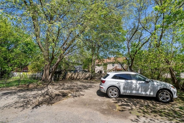 view of parking featuring fence