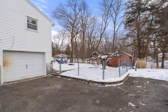 yard covered in snow featuring a garage