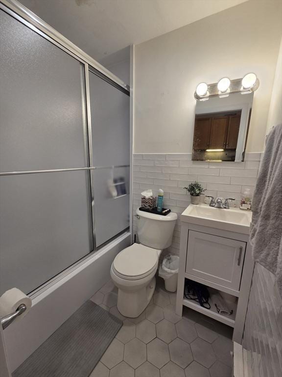 26 Unity St Unit 2, Boston, MA 02113 - full bathroom featuring vanity, toilet, bath / shower combo with glass door, tile patterned floors, and tile walls