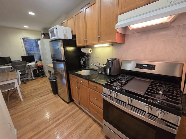 26 Unity St Unit 2, Boston, MA 02113 - kitchen with stainless steel appliances, under cabinet range hood, light wood-style floors, a sink, and recessed lighting