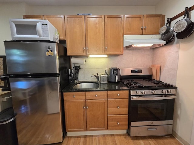 26 Unity St Unit 2, Boston, MA 02113 - kitchen with stainless steel appliances, under cabinet range hood, a sink, and light wood-type flooring