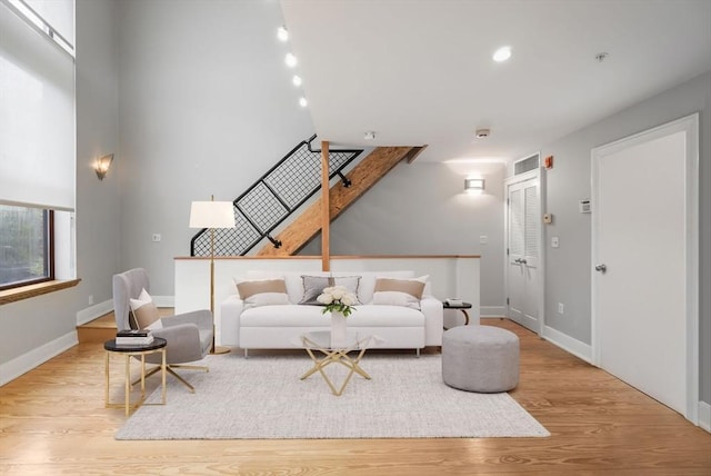 living area with baseboards and wood finished floors