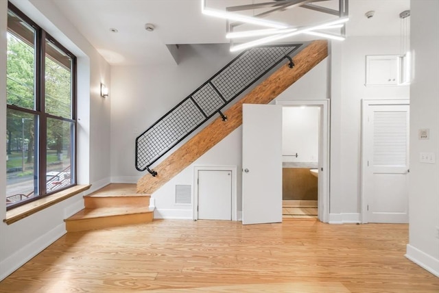 interior space with baseboards, visible vents, and wood finished floors