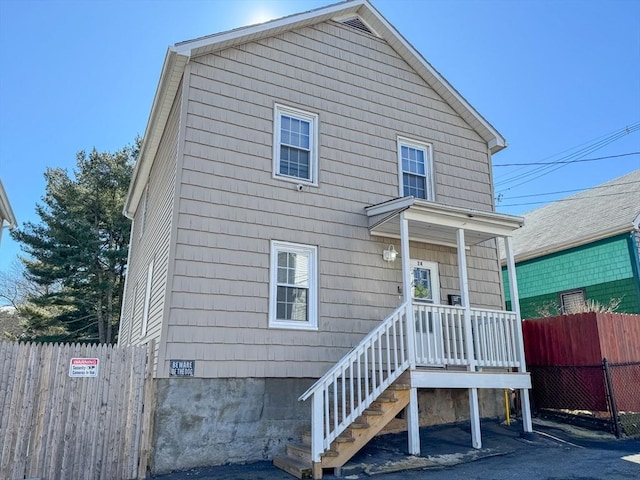 view of front of property featuring fence