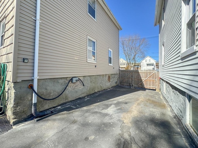 view of home's exterior with fence and a patio