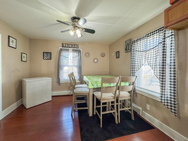 dining space featuring baseboards, ceiling fan, dark wood-style flooring, and a healthy amount of sunlight