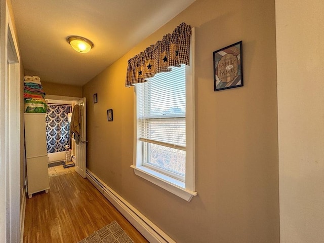 hallway featuring dark wood-type flooring and baseboards