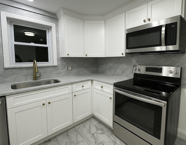 45 Carter Ave, Blackstone, MA 01504 - kitchen featuring stainless steel appliances, a sink, light marble finish flooring, and light countertops