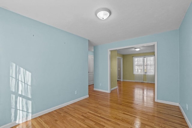 unfurnished room featuring light wood-style floors and baseboards