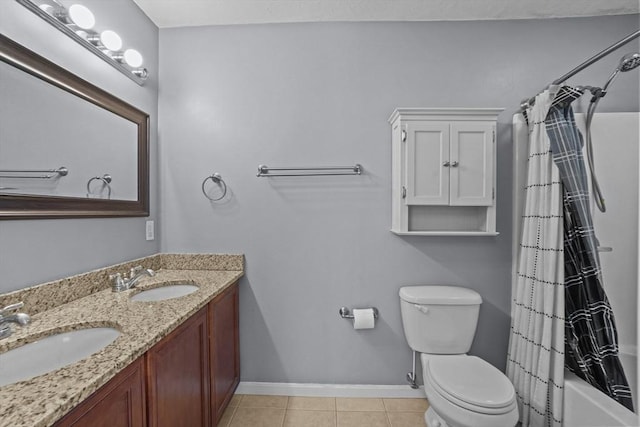 bathroom featuring toilet, baseboards, double vanity, tile patterned floors, and shower / bath combo with shower curtain