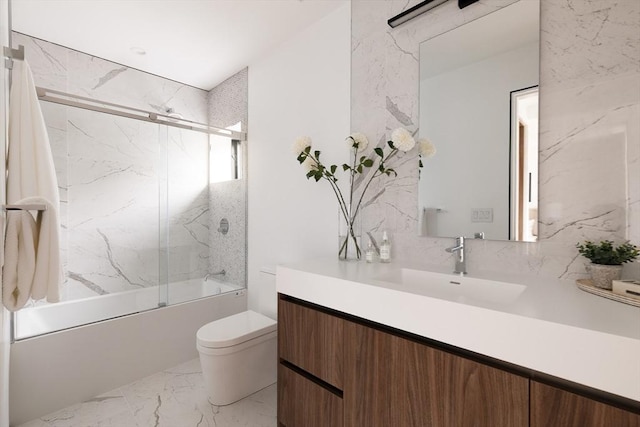 full bathroom with toilet, vanity, and combined bath / shower with glass door