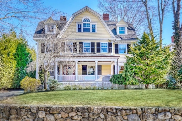 10 Sheffield Rd, Winchester, MA 01890 - view of front of house featuring a porch, a chimney, and a front yard