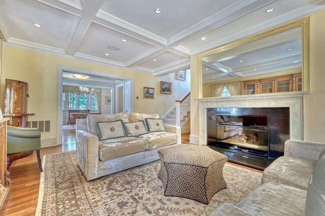 10 Sheffield Rd, Winchester, MA 01890 - living room featuring wood finished floors, coffered ceiling, crown molding, a fireplace, and beam ceiling