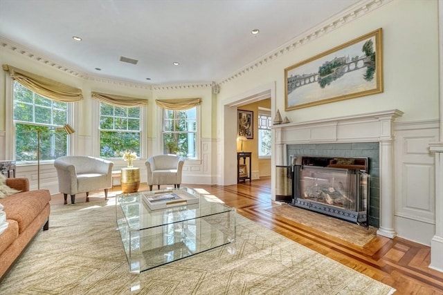 10 Sheffield Rd, Winchester, MA 01890 - living room with a fireplace, healthy amount of natural light, a decorative wall, a wainscoted wall, and wood finished floors