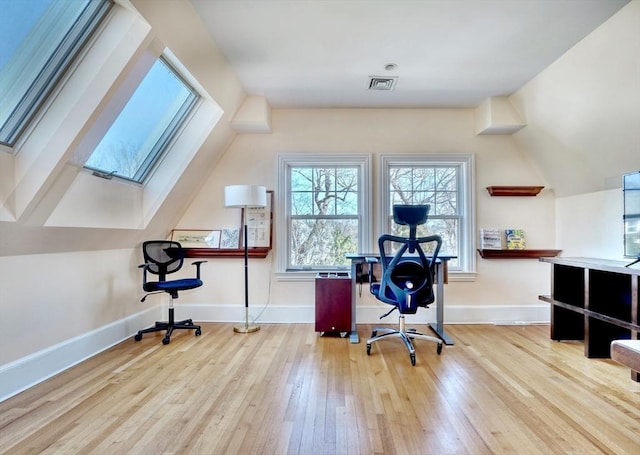 10 Sheffield Rd, Winchester, MA 01890 - home office with wood-type flooring, healthy amount of natural light, a skylight, baseboards, and lofted ceiling
