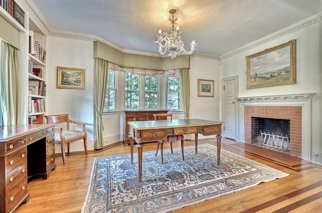 10 Sheffield Rd, Winchester, MA 01890 - home office with light wood-style flooring, a chandelier, a brick fireplace, ornamental molding, and baseboards