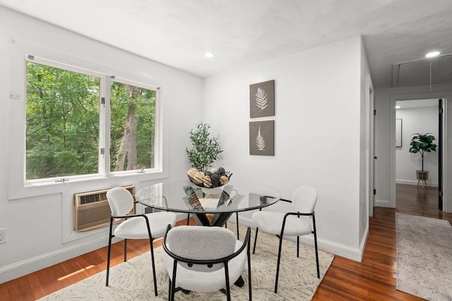 379 Dedham Ave, Needham, MA 02492 - dining area with baseboards, wood finished floors, an AC wall unit, and recessed lighting