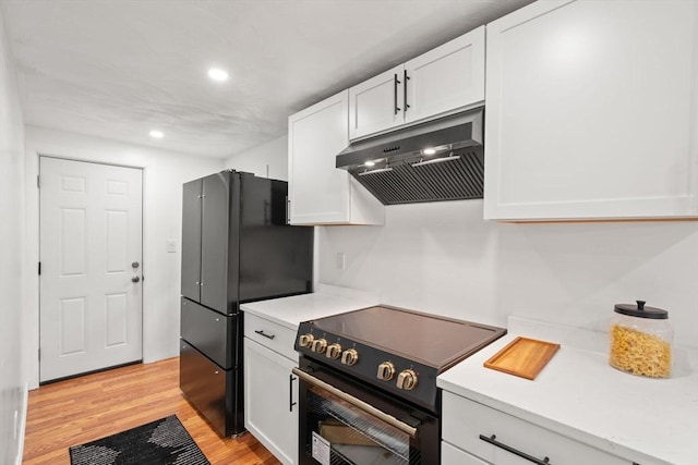 379 Dedham Ave, Needham, MA 02492 - kitchen with under cabinet range hood, black appliances, white cabinets, light countertops, and light wood-style flooring