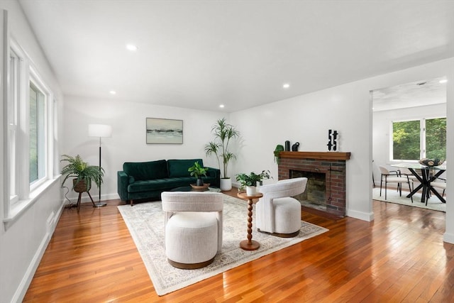 379 Dedham Ave, Needham, MA 02492 - living room featuring hardwood / wood-style floors, a brick fireplace, baseboards, and recessed lighting