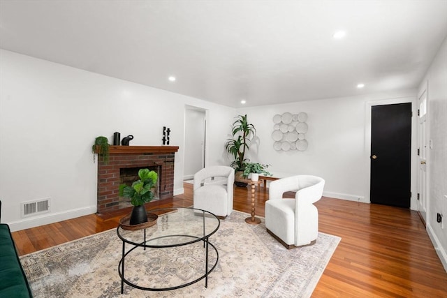 379 Dedham Ave, Needham, MA 02492 - living area with wood finished floors, a fireplace, recessed lighting, and baseboards
