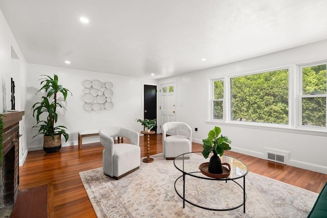 379 Dedham Ave, Needham, MA 02492 - living area featuring healthy amount of natural light, a fireplace, wood finished floors, and recessed lighting