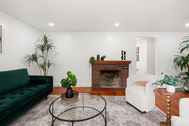 379 Dedham Ave, Needham, MA 02492 - living area with wood finished floors, recessed lighting, a fireplace, and baseboards