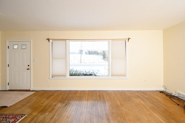 interior space with baseboards and hardwood / wood-style flooring