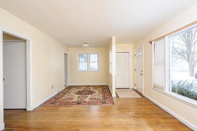 entryway with light wood-type flooring and baseboards