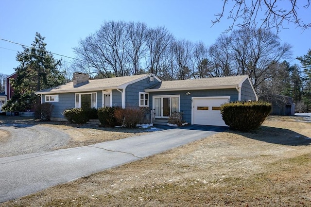 single story home with a garage, driveway, and a chimney