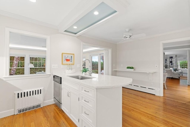28 Pleasant View Rd, Arlington, MA 02476 - kitchen featuring radiator heating unit, dishwasher, a peninsula, a baseboard radiator, and white cabinetry