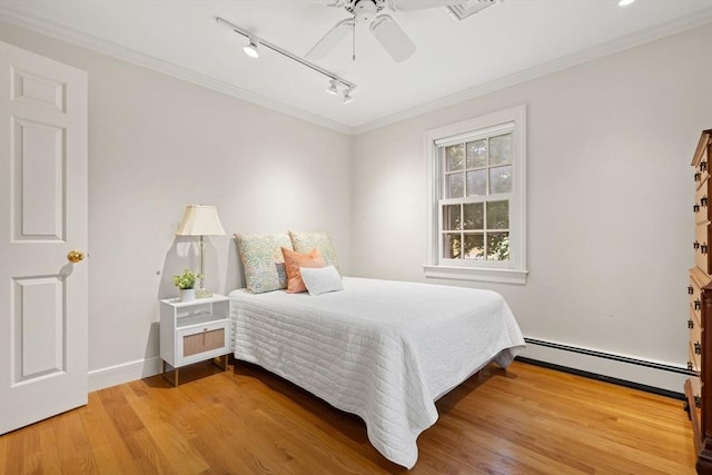 28 Pleasant View Rd, Arlington, MA 02476 - bedroom with a baseboard radiator, rail lighting, wood finished floors, a ceiling fan, and crown molding