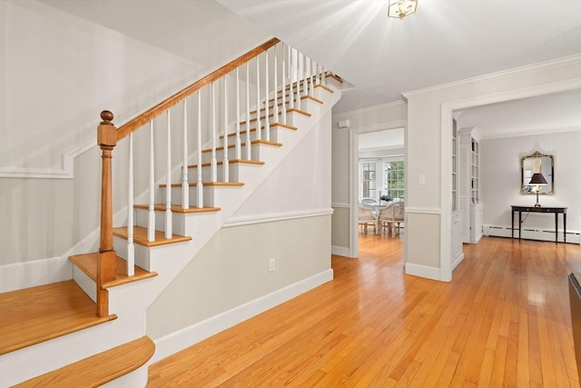 28 Pleasant View Rd, Arlington, MA 02476 - stairway featuring crown molding, a baseboard radiator, and hardwood / wood-style floors