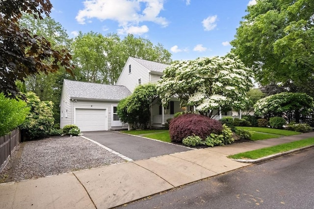 28 Pleasant View Rd, Arlington, MA 02476 - obstructed view of property with an attached garage, asphalt driveway, and a shingled roof