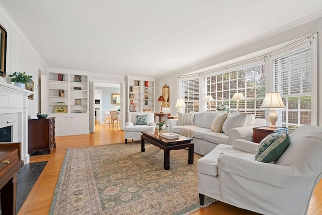 28 Pleasant View Rd, Arlington, MA 02476 - living area with built in shelves, light wood finished floors, ornamental molding, and a fireplace with flush hearth