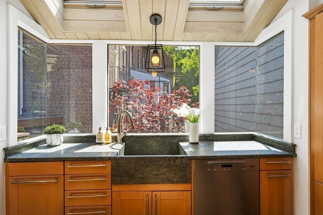 bar featuring dark stone countertops, hanging light fixtures, stainless steel dishwasher, and sink