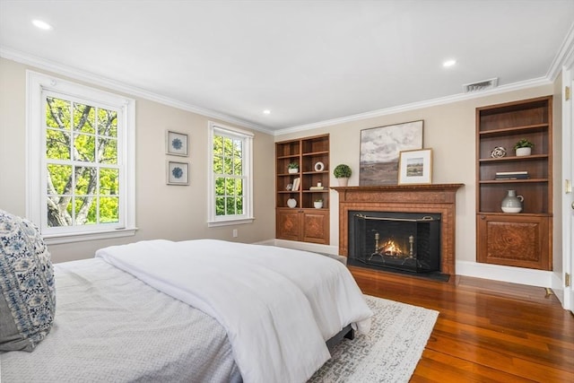 bedroom with dark hardwood / wood-style flooring and ornamental molding