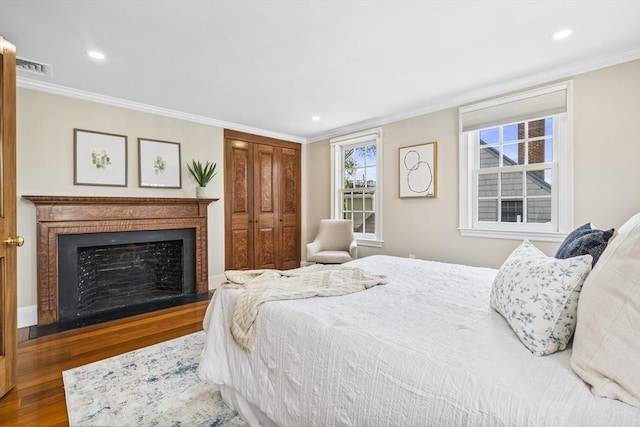 bedroom with dark wood-type flooring and ornamental molding