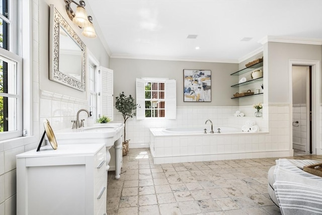 bathroom featuring plenty of natural light, a relaxing tiled tub, and ornamental molding