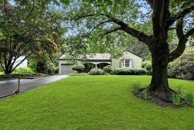 149 N Main St, South Hadley, MA 01075 - view of front of home featuring concrete driveway, a front yard, and a garage