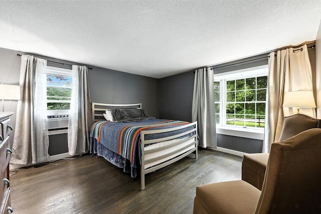 149 N Main St, South Hadley, MA 01075 - bedroom with multiple windows, dark wood finished floors, a textured ceiling, and cooling unit