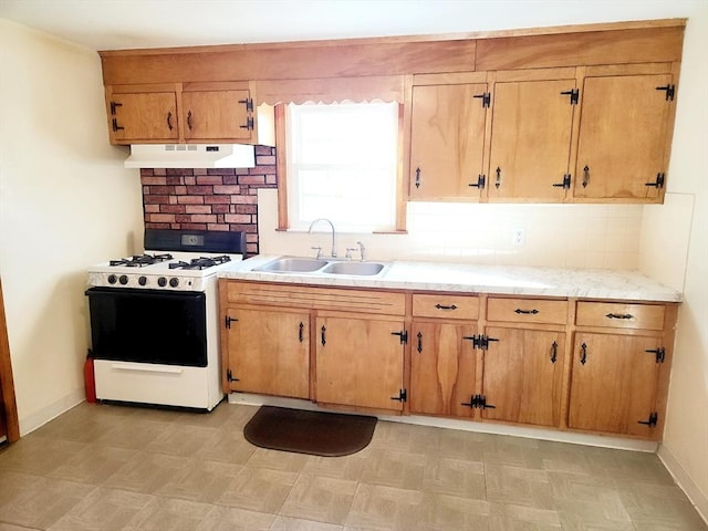 kitchen featuring sink and white range with gas cooktop