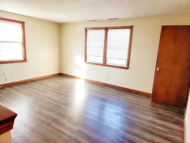 unfurnished room with hardwood / wood-style floors