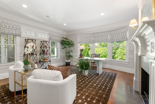 sunroom featuring plenty of natural light and a fireplace with flush hearth