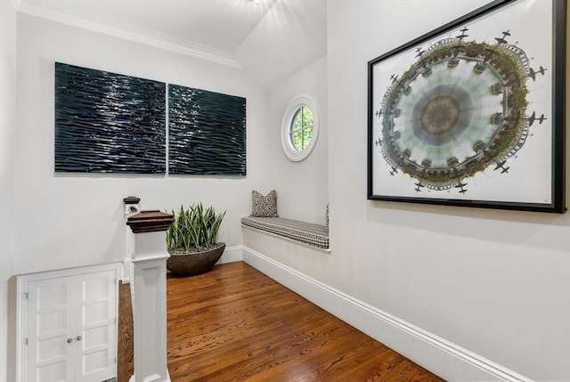 hall with crown molding, baseboards, and wood finished floors