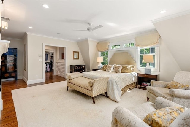 bedroom with dark wood-style floors, recessed lighting, visible vents, ornamental molding, and baseboards