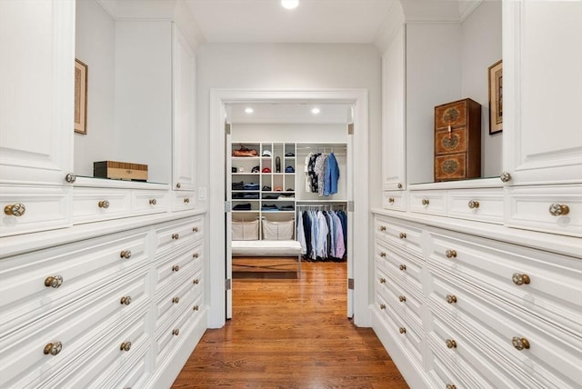 hall featuring wood finished floors and recessed lighting