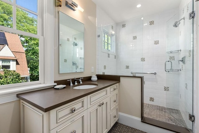 bathroom featuring a stall shower and vanity